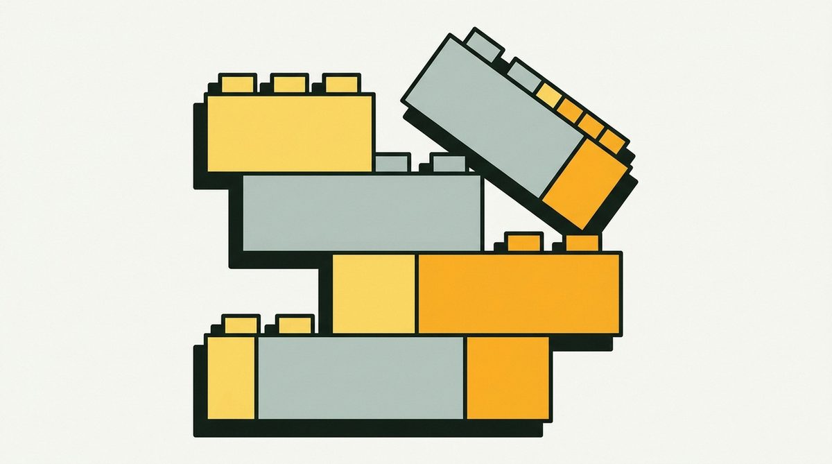 Chunky interlocking building bricks stacked slightly off-axis, with one brick tilted away from the stack as if just placed.